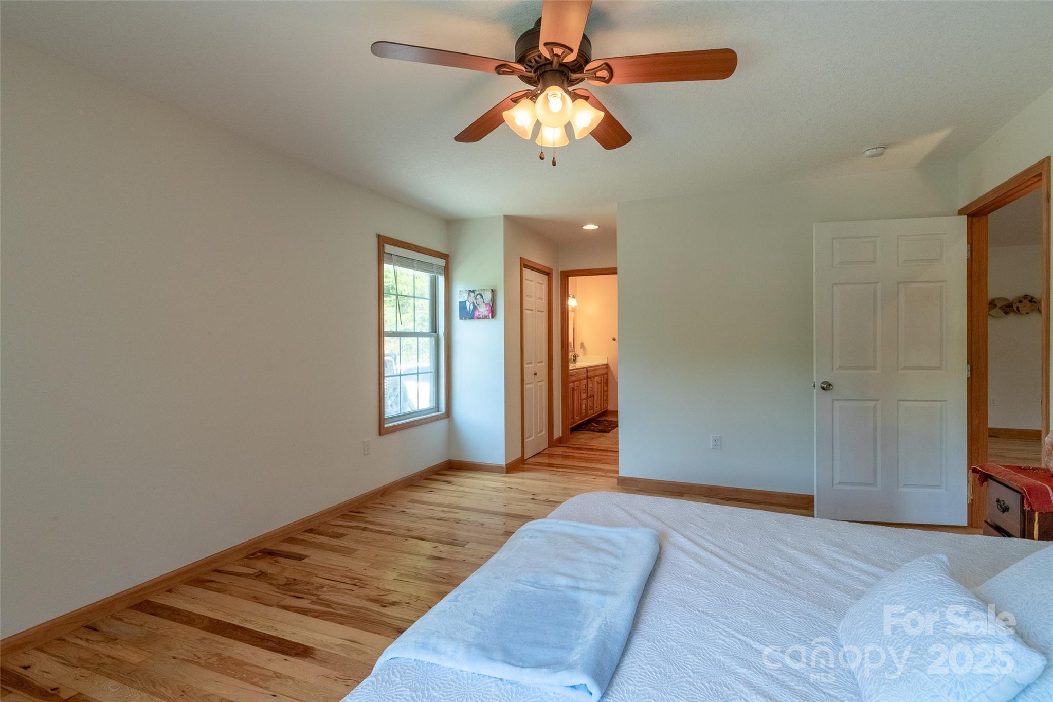 980 South River Road Sylva, NC 28779 - Photo 12 of 41 a bedroom with a bed and a chandelier
