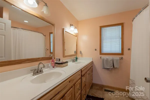 a bathroom with a double vanity sink and mirror