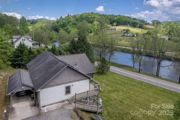 an aerial view of a house with swimming pool and garden view