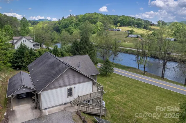 an aerial view of a house with swimming pool and garden view