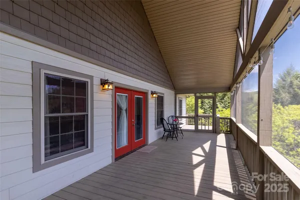 a view of a house with backyard and deck