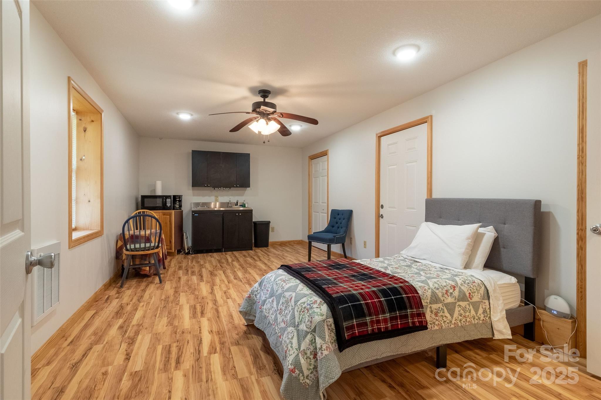 980 South River Road Sylva, NC 28779 - Photo 38 of 41 a spacious bedroom with a bed and wooden floor