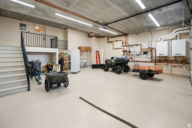 1141 South Oak Leaf Lane Springville, UT 84663 - Photo 112 of 147 LOWER Multi-purpose garage space featuring a concrete ceiling, industrial lighting, and a neutral-toned epoxy floor
