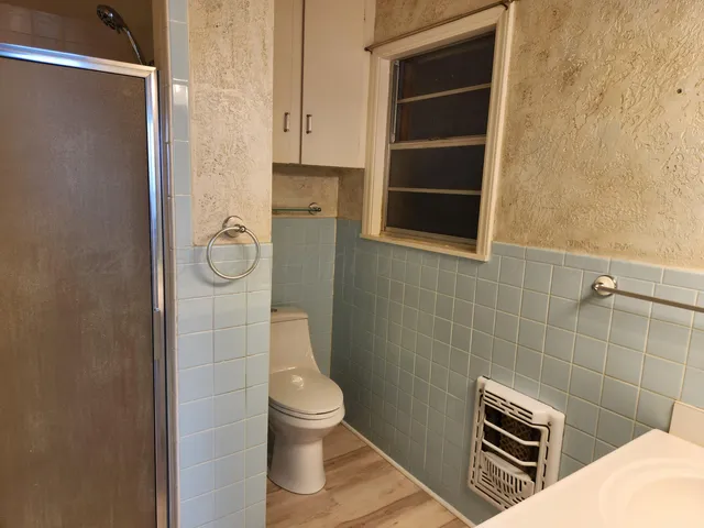 a bathroom with a toilet and a shower