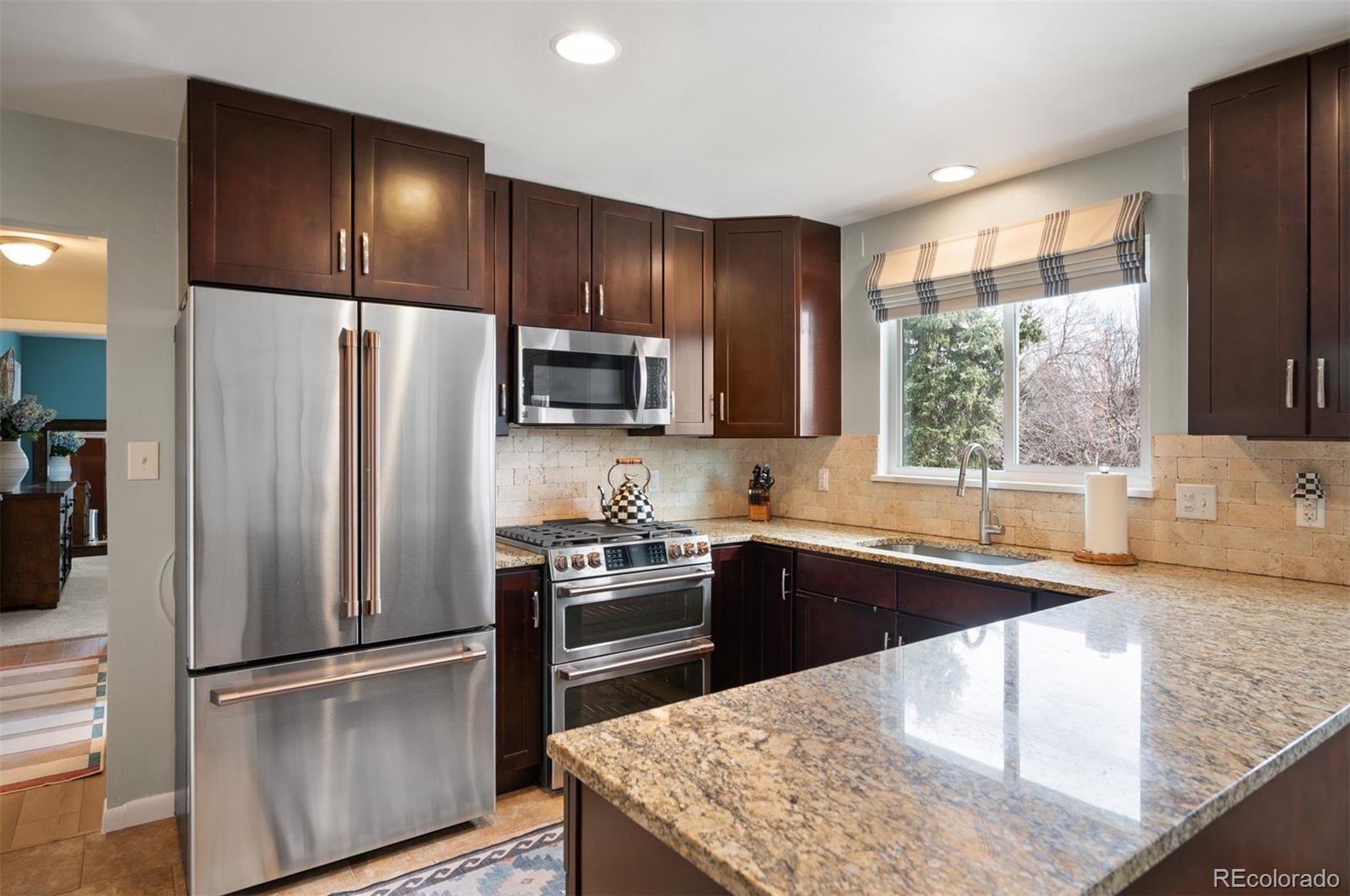4 Skyline Drive Wheat Ridge, CO 80215 - Photo 12 of 41 a kitchen with granite countertop a refrigerator stove and sink