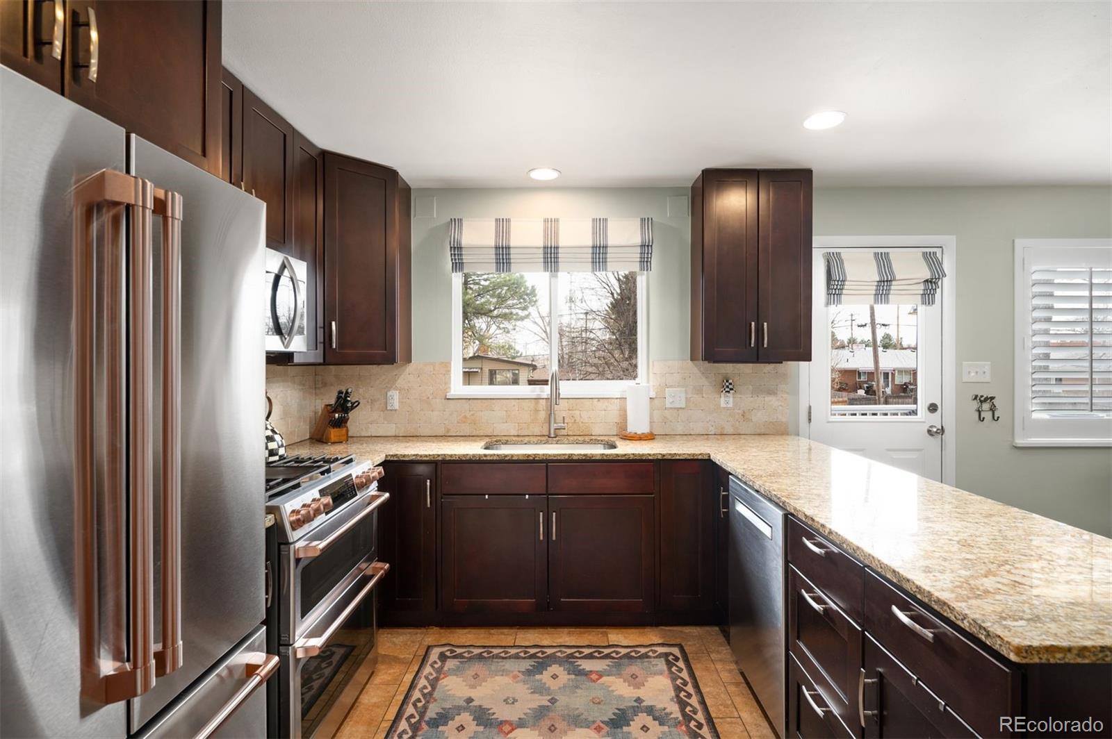 4 Skyline Drive Wheat Ridge, CO 80215 - Photo 13 of 41 a kitchen with a sink stove and refrigerator