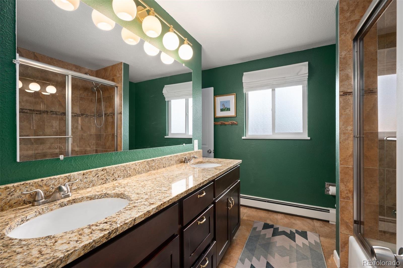 4 Skyline Drive Wheat Ridge, CO 80215 - Photo 19 of 41 a bathroom with a sink and a large mirror