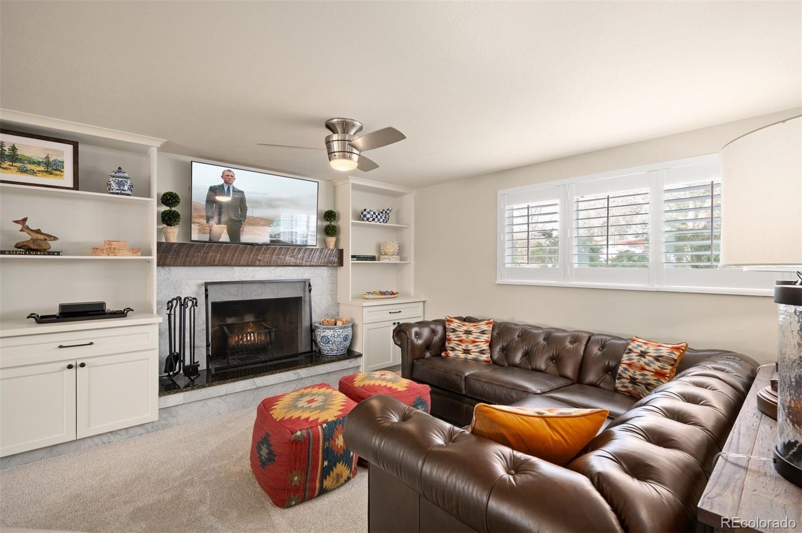 4 Skyline Drive Wheat Ridge, CO 80215 - Photo 21 of 41 a living room with furniture a fireplace and a window
