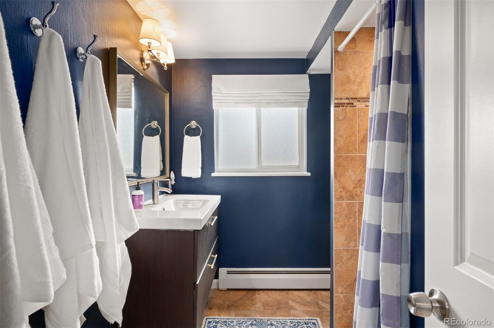4 Skyline Drive Wheat Ridge, CO 80215 - Photo 22 of 41 a bathroom with a sink vanity and a mirror