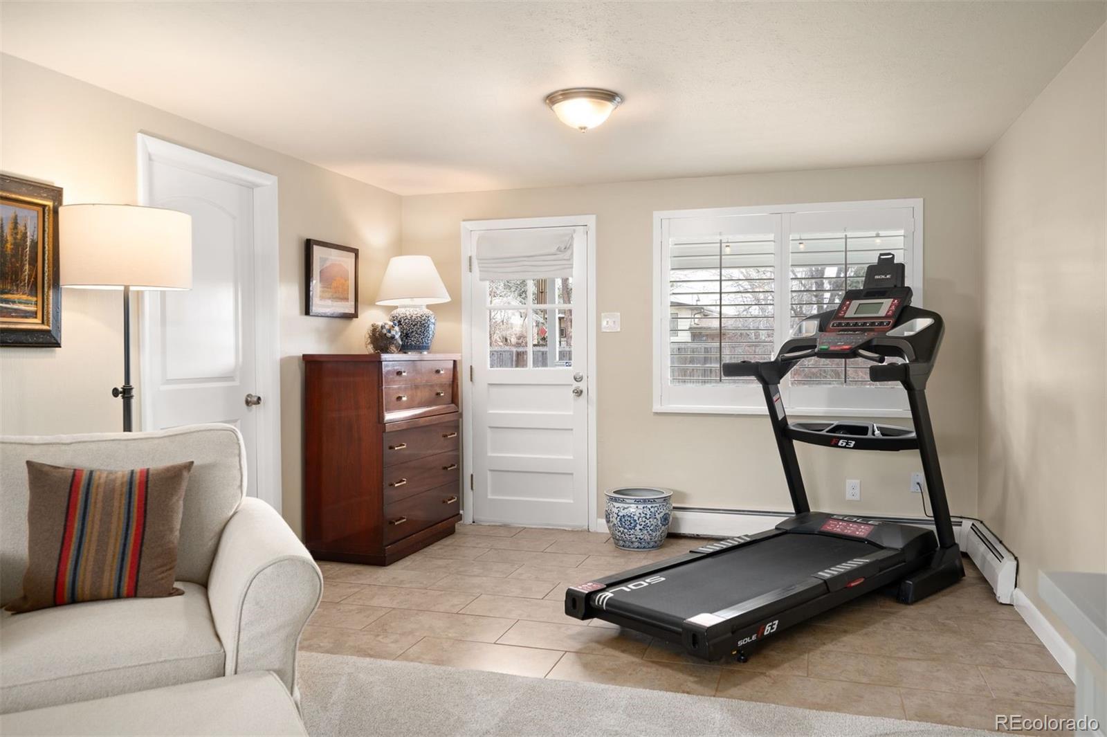 4 Skyline Drive Wheat Ridge, CO 80215 - Photo 25 of 41 a room with a couch and gym equipment