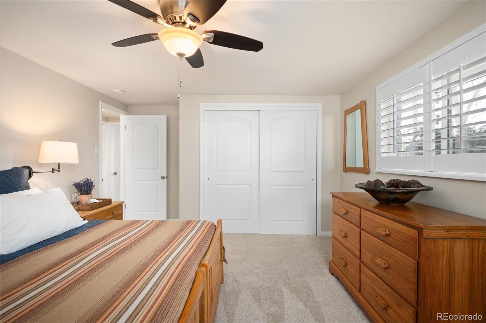 4 Skyline Drive Wheat Ridge, CO 80215 - Photo 30 of 41 a bedroom with a bed and a chandelier