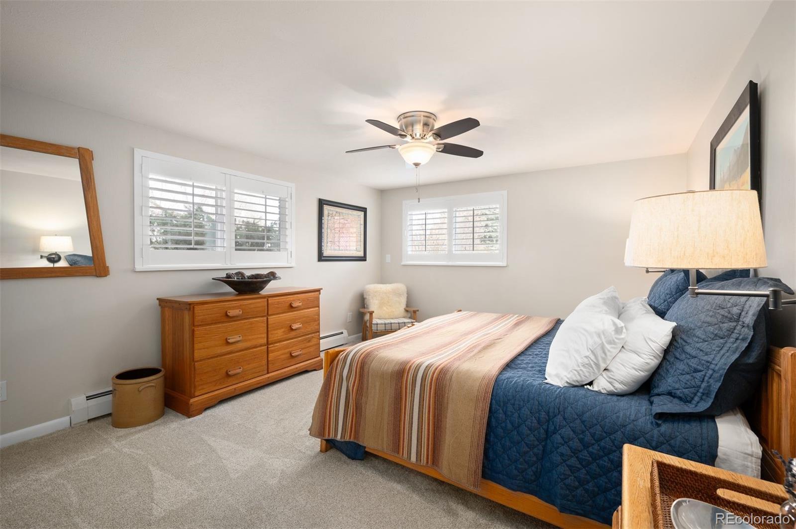 4 Skyline Drive Wheat Ridge, CO 80215 - Photo 31 of 41 a bedroom with a bed and wooden floor