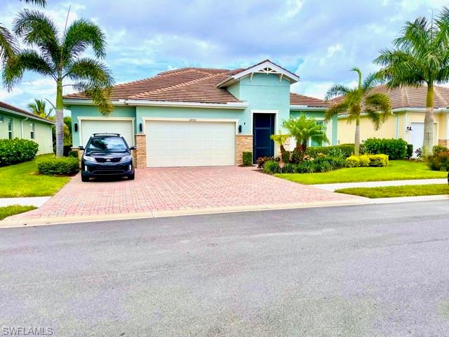 14726 Nautilus Place Naples, FL 34114 - Photo 1 of 21 a front view of a house with a garden and plants