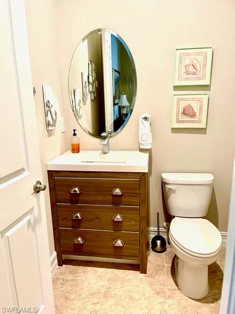 14726 Nautilus Place Naples, FL 34114 - Photo 16 of 21 a bathroom with a toilet a sink and mirror
