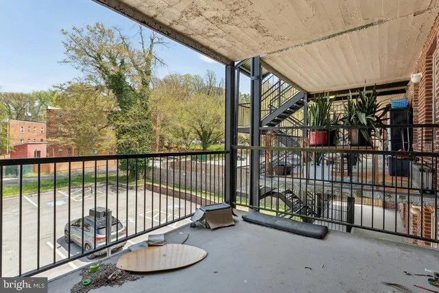a view of a porch with a table and chairs