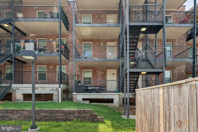 a front view of a building with a garden