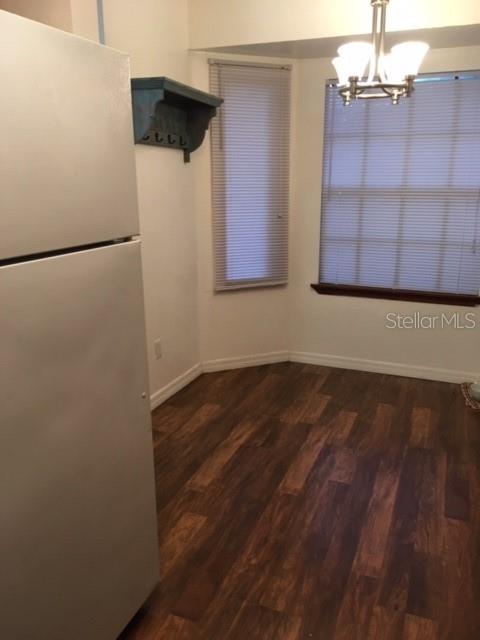1712 Southwest 67th Terrace Gainesville, FL 32607 - Photo 6 of 10 a view of a room with wooden floor and cabinet