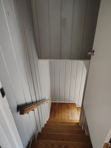 a view of a kitchen with furniture and wooden floor