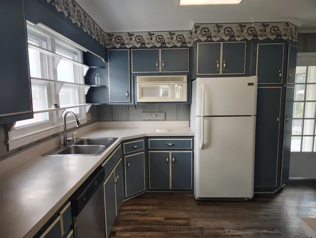 a kitchen with a refrigerator and a sink