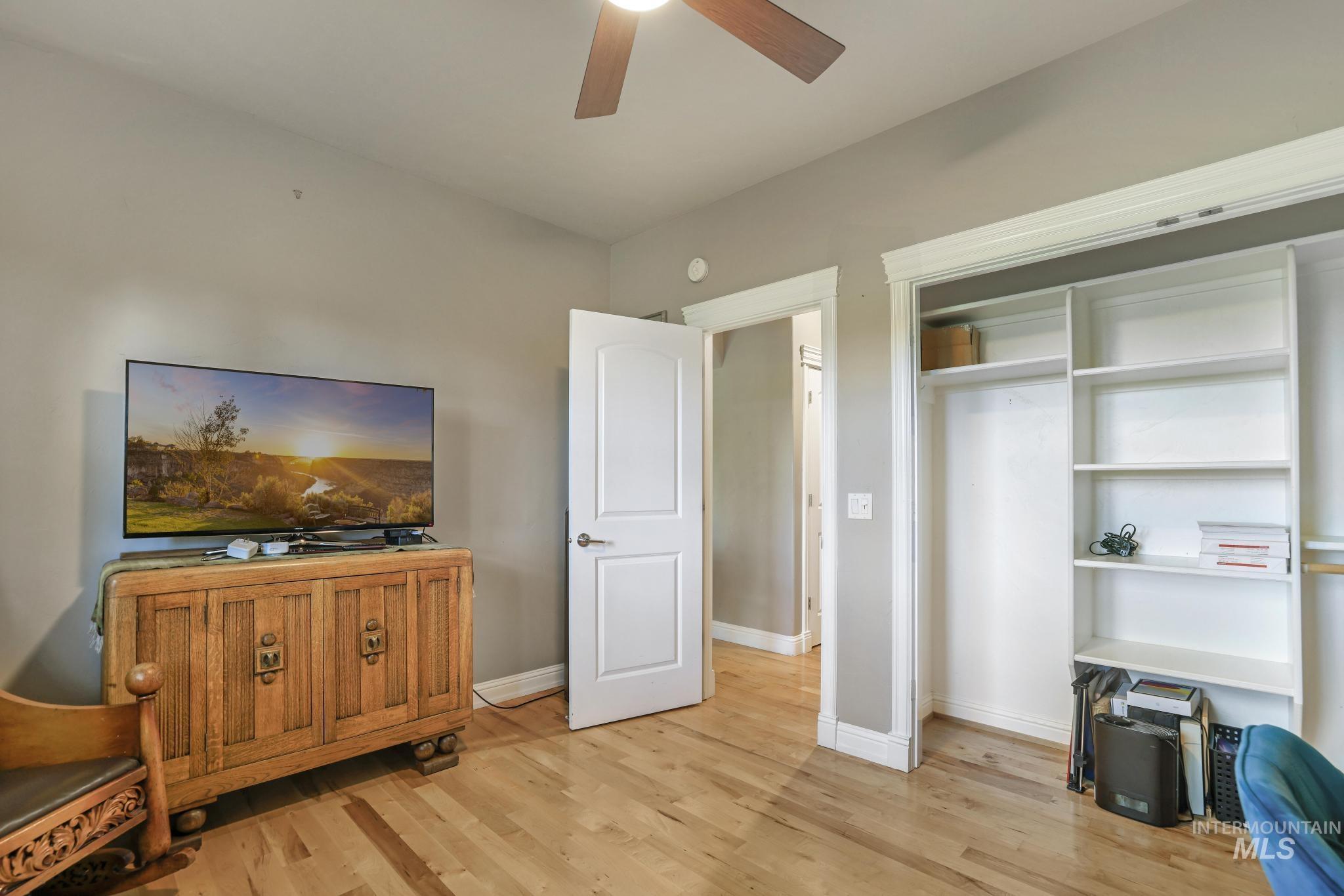 100 Olympic Road Jerome, ID 83338 - Photo 26 of 50 Interior room featuring wood-finish flooring, a ceiling fan with wood-toned blades, and light gray wall paint