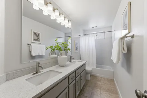 a bathroom with a sink a mirror and a shower