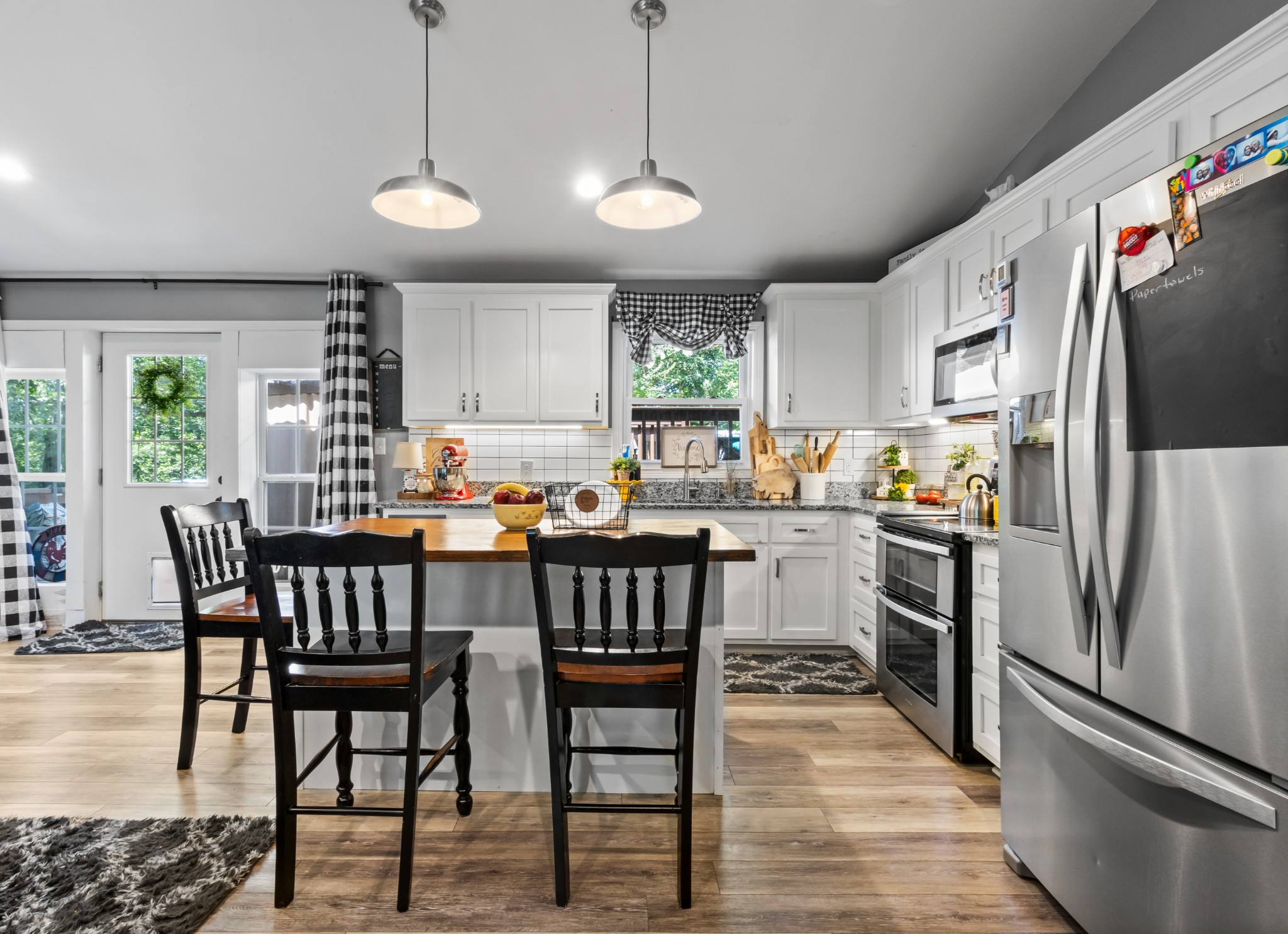 408 Sandy Road Dover, TN 37058 - Photo 7 of 36 a kitchen with stainless steel appliances granite countertop a stove a refrigerator a kitchen island a dining table and chairs