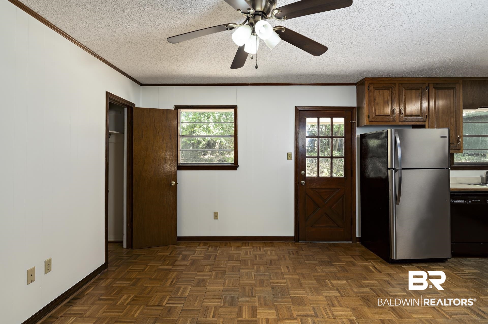 707 Johnson Avenue Fairhope, AL 36532 - Photo 18 of 38 Kitchen with baseboards, freestanding refrigerator, dishwasher, and a textured ceiling