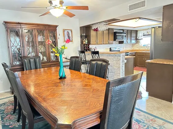 a dining table with chairs and window