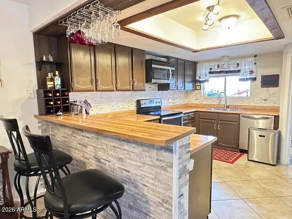 a kitchen with cabinets and chairs in it