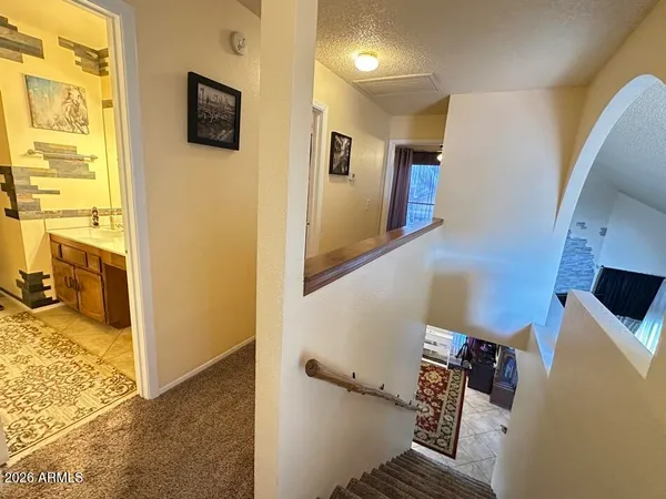 a view of a livingroom with wooden floor and a flat screen tv