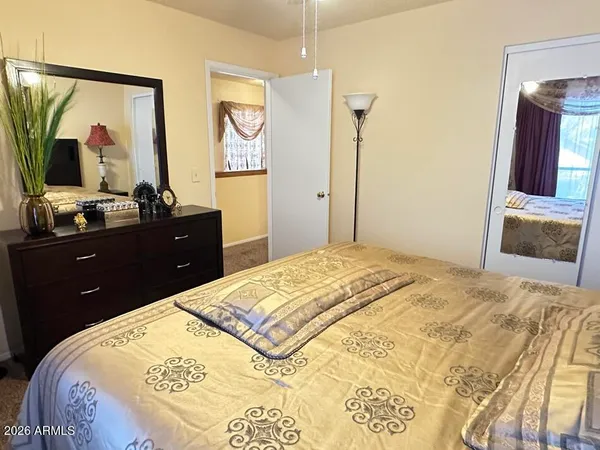 a bedroom with a bed and a dresser