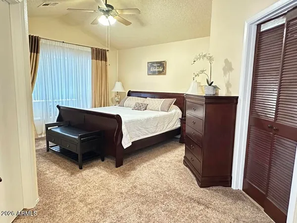 a living room with a bed furniture and a window