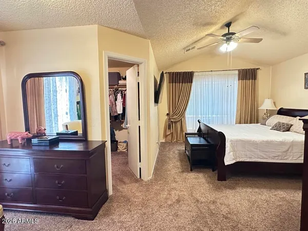 a bedroom with a bed and a dresser