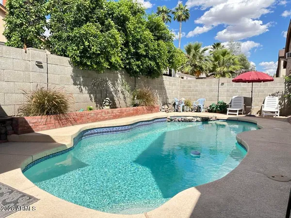 a view of a swimming pool with a yard