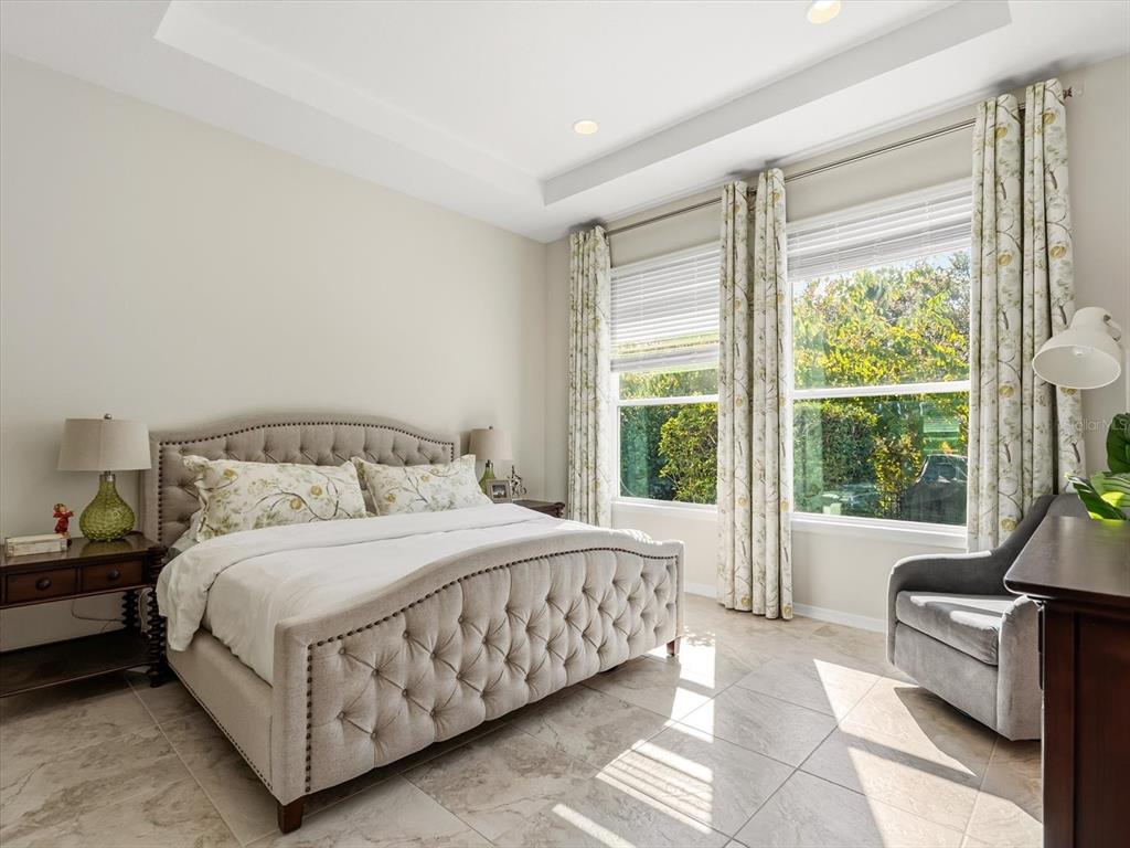17422 Channel Way Winter Garden, FL 34787 - Photo 18 of 44 a bedroom with a bed couch and a large window