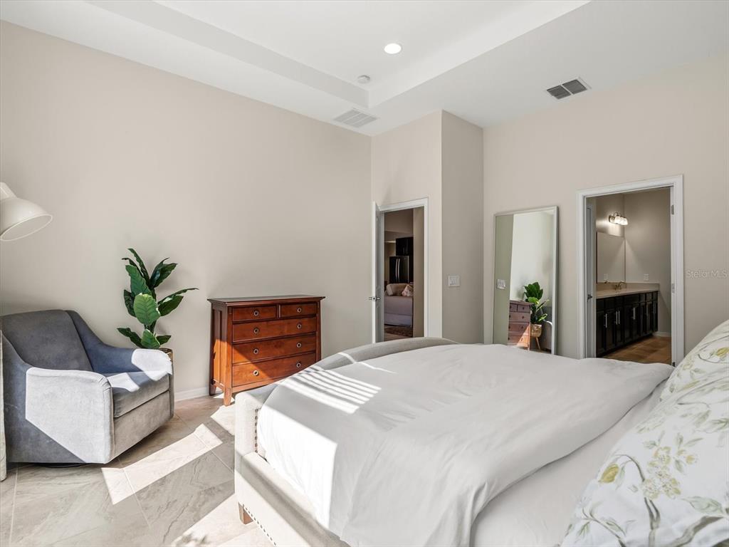 17422 Channel Way Winter Garden, FL 34787 - Photo 19 of 44 a bedroom with a large bed and a potted plant