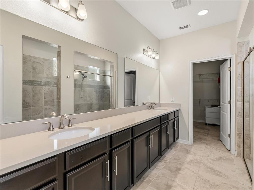17422 Channel Way Winter Garden, FL 34787 - Photo 20 of 44 a spacious bathroom with a granite countertop sink a toilet and a shower