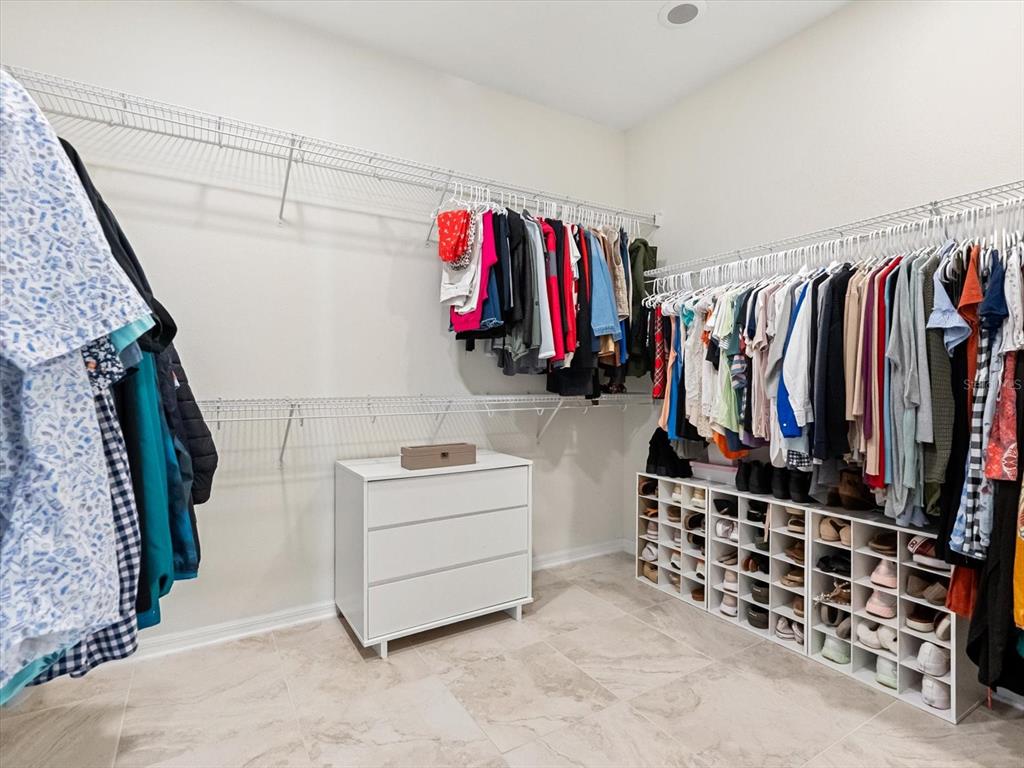 17422 Channel Way Winter Garden, FL 34787 - Photo 22 of 44 a view of walk in closet with clothes