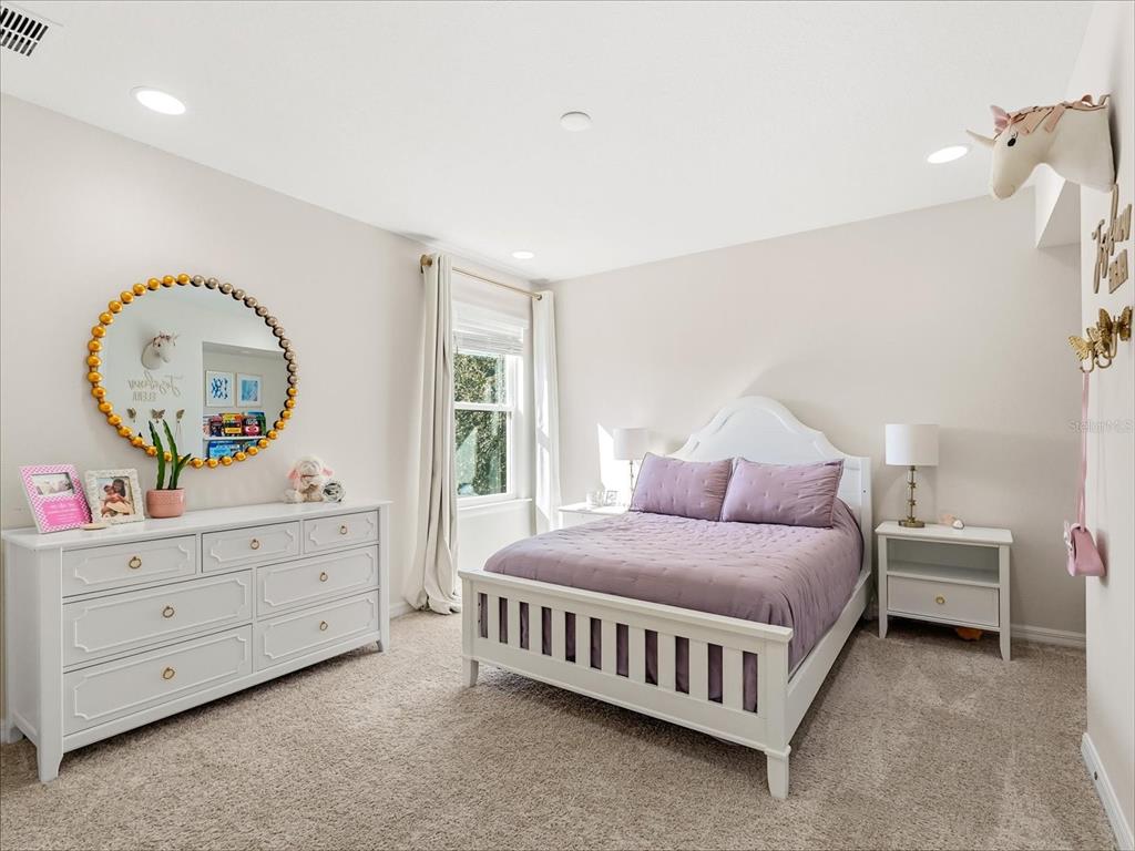17422 Channel Way Winter Garden, FL 34787 - Photo 30 of 44 a bed room with a bed and a mirror