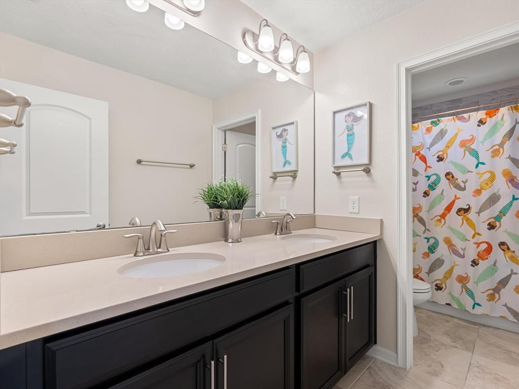 17422 Channel Way Winter Garden, FL 34787 - Photo 32 of 44 a bathroom with a sink double vanity and a mirror