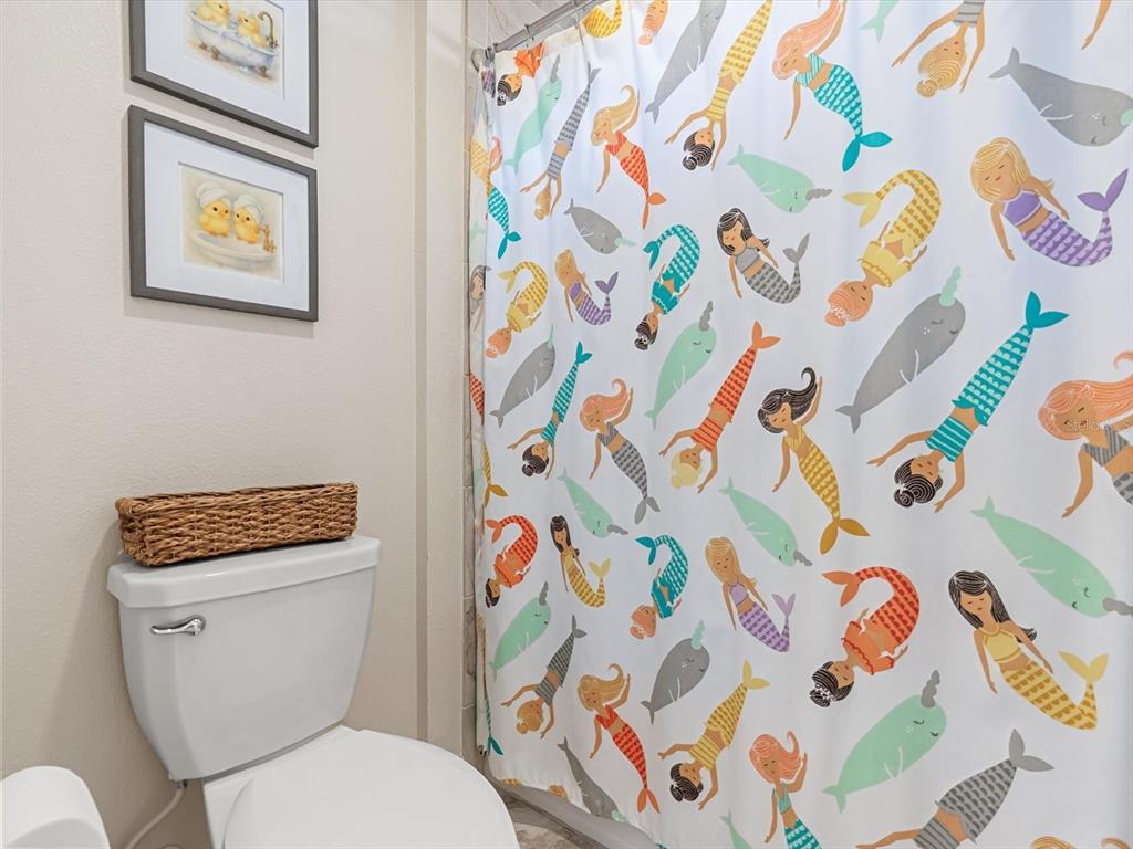 17422 Channel Way Winter Garden, FL 34787 - Photo 33 of 44 a white toilet sitting next to a shower curtain