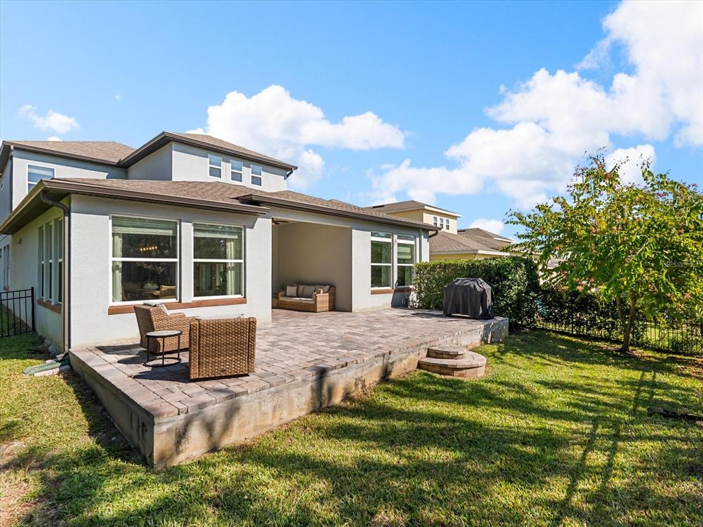 17422 Channel Way Winter Garden, FL 34787 - Photo 37 of 44 a backyard of a house with yard fire pit barbeque oven and outdoor seating
