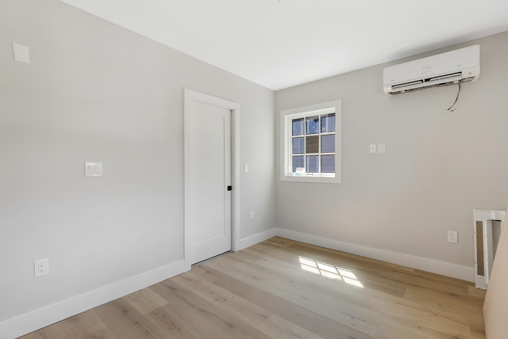 8 Crystal Street, Unit 2 Melrose, MA 02176 - Photo 11 of 17 a view of empty room with wooden floor and fan
