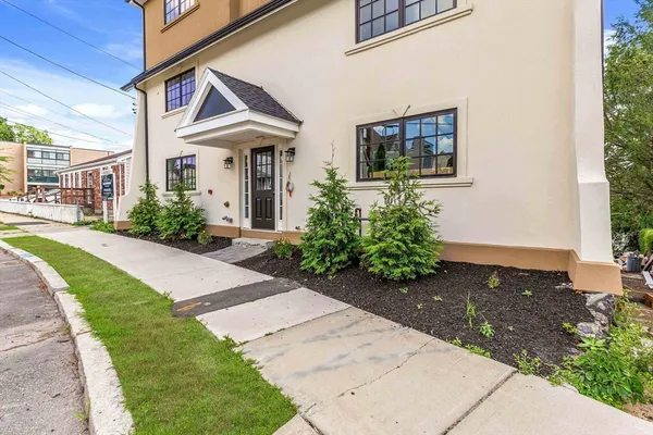 a front view of a house with garden