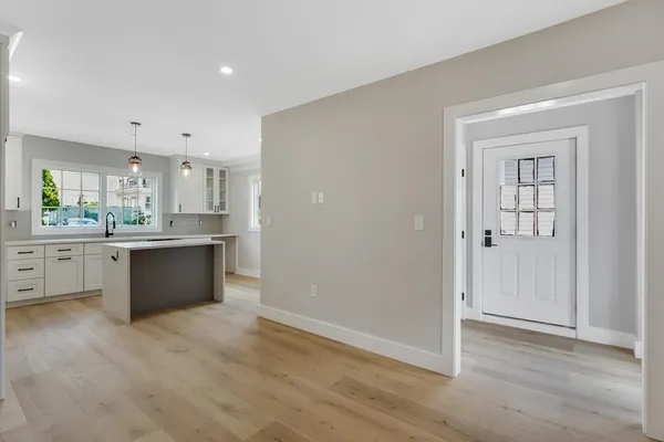 a large kitchen with a refrigerator and a stove top oven