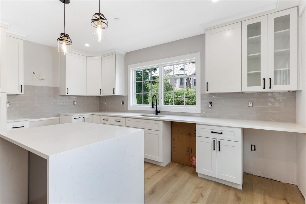 8 Crystal Street, Unit 2 Melrose, MA 02176 - Photo 5 of 17 a kitchen with a sink cabinets and window