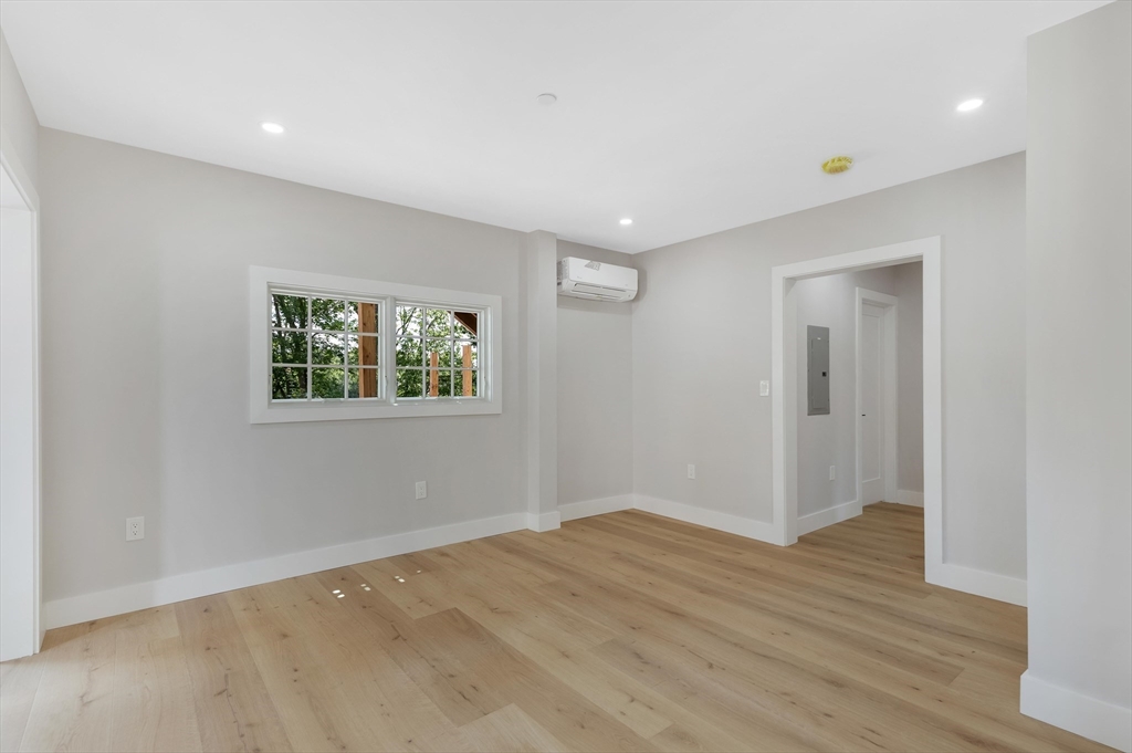 8 Crystal Street, Unit 2 Melrose, MA 02176 - Photo 8 of 17 a view of an empty room with wooden floor and a window