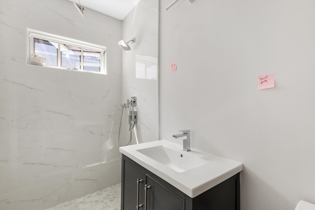 8 Crystal Street, Unit 2 Melrose, MA 02176 - Photo 10 of 17 a bathroom with a sink and a mirror