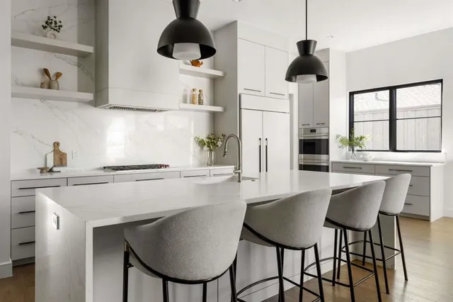 a large white kitchen with a lot of counter space