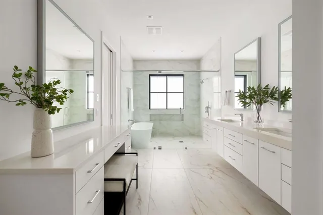 a spacious bathroom with a shower sink and mirror